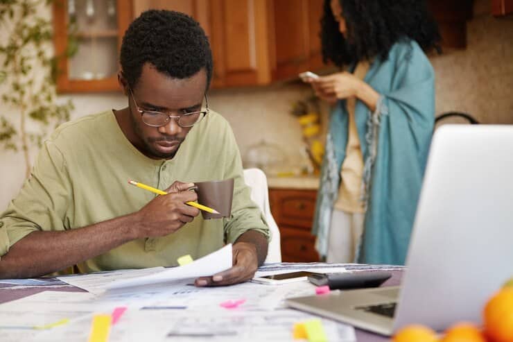 young african american man glasses drinking coffee busy working through finances 273609 9216