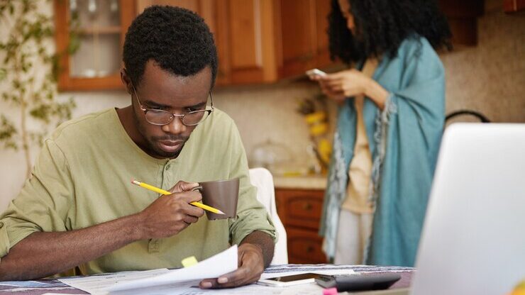 young african american man glasses drinking coffee busy working through finances 273609 9216 1 edited