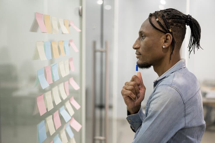 side view man thinking office while looking sticky notes 23 2148502222